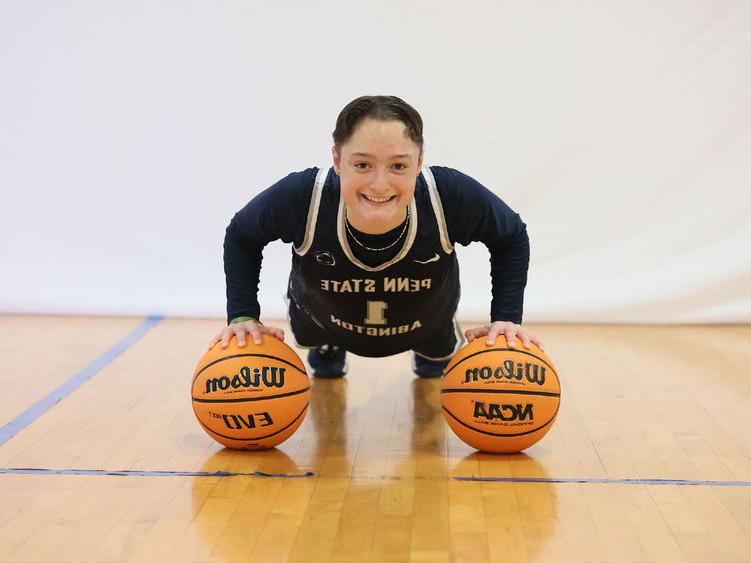 Athlete balancing on two basketballs